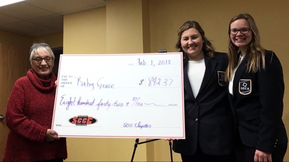 DECA presents Baby Grace with Donation Check