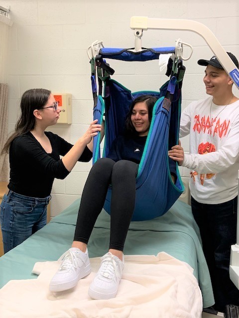 Students in Ms. Riley's Health Science class using the Hoyer Lift.